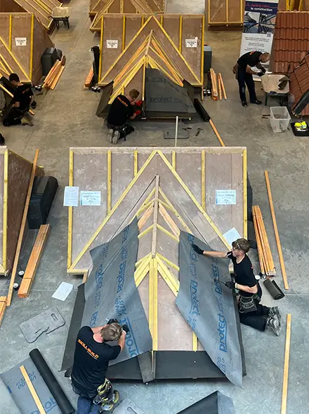 SkillBuild competitors installing Glidevale Protect's VP400 roofing membrane on roofing rigs