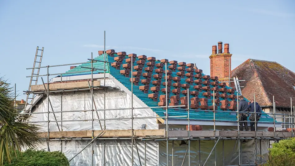 Stripped roof with tiles placed ready for reroofing