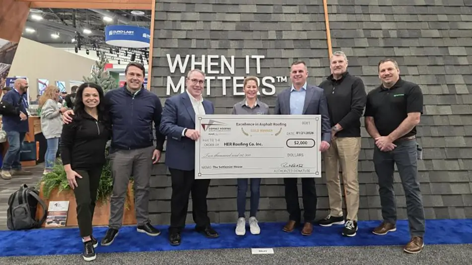 HER Roofing Co pictured with their award
