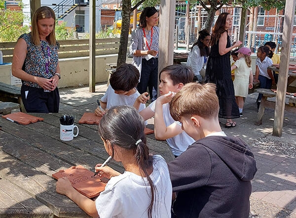 The Alfred Sutton School pupils decorating their clay tiles for the re-roof