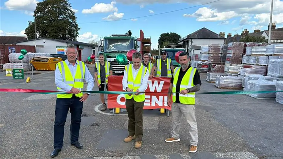 Matthew Parker cuts the ribbon at the official opening of Chandlers Roofing Supplies Faversham alongside colleagues, customers and supplier partners