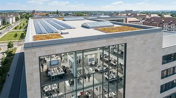 Roof of a commercial building with green areas and solar panels installed
