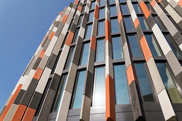 Example of a building with piers either side of the windows to create shading. Preferable to flat glazed facades