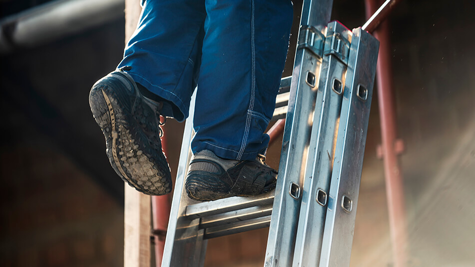 Tradesperson using a ladder