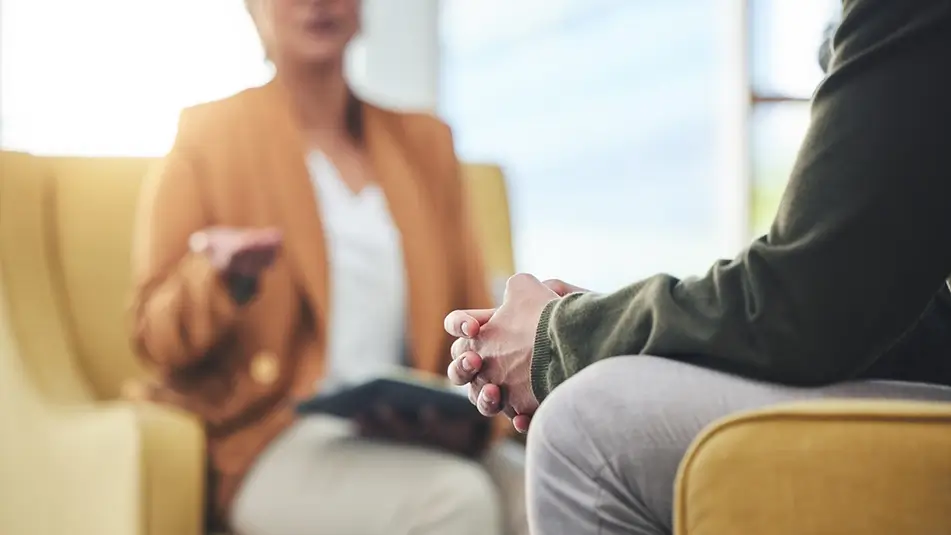 Two people sat in office having mental health chat