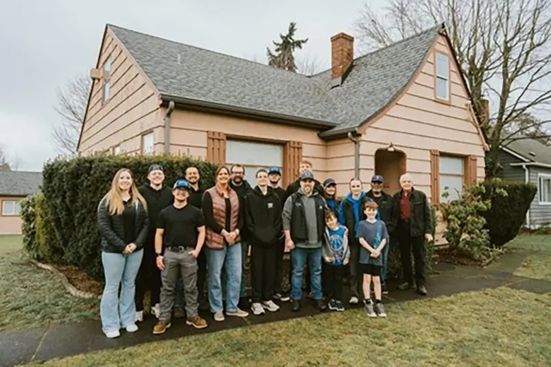 Kitsap Roofing install team pictured outside the refurbished shelter