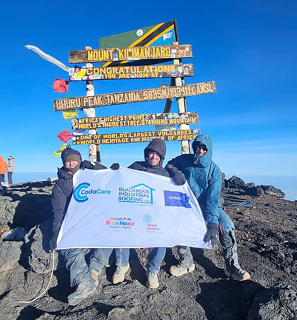 Sean Lynden, Andy Nuttall and Kevin Clough pose for picture at Mount Kilimanjaro summit