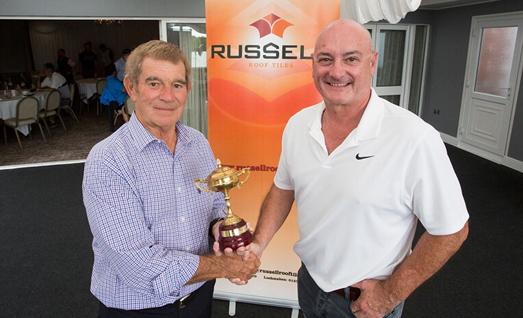 Henry Newton former footballer receiving the RRT Ryder Cup Trophy from Andrew Hayward Managing Director at RRT