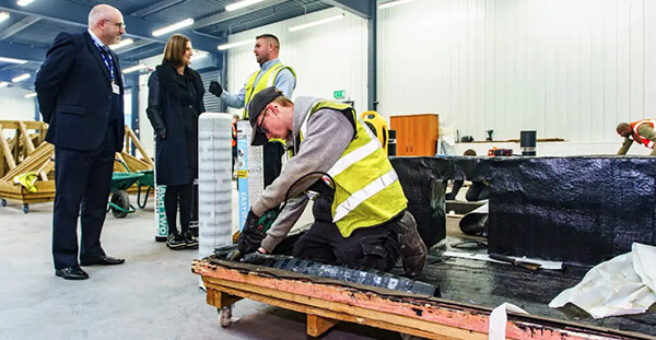 Roofing apprentice practicing flat roofing on training rig