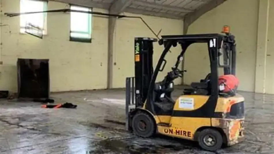 The fork lift truck used with the bucket in the background