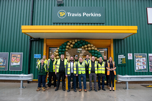 Travis Perkins staff pose for photo in front of new branch building