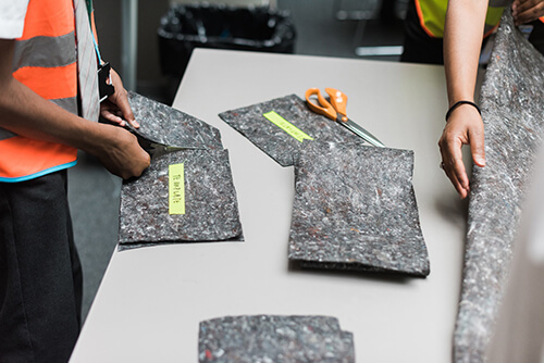 Pieces of roofing geotextile used by schoolchildren for design