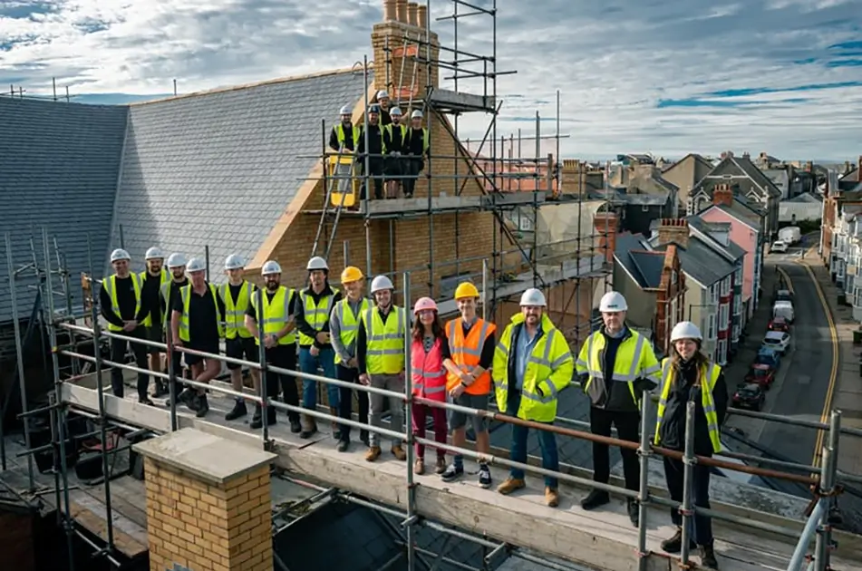 The construction team pose for a photo on the roof of Ceredigion Museum