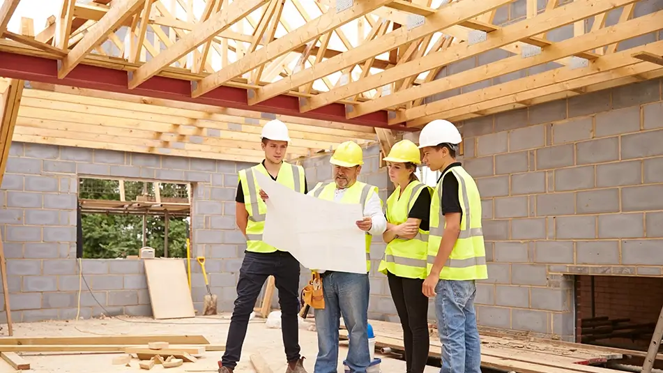 Students dressed in PPE on work placement at a construction site 